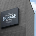 Free Wall Mounted Company Logo Signage Board on Building Mockup PSD